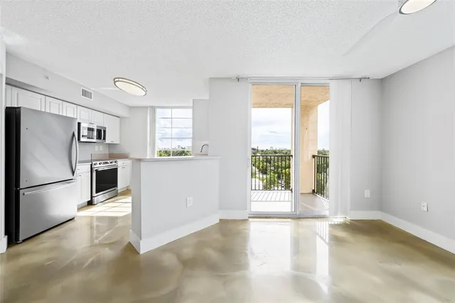 a view of a kitchen with a refrigerator cabinets and a large window