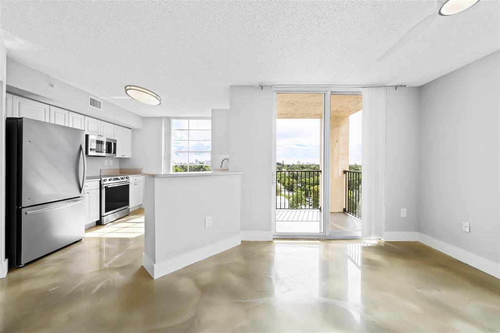520 Southeast 5th Avenue, Unit 1504 Fort Lauderdale, FL 33301 - Photo 2 of 53 a view of a kitchen with a refrigerator cabinets and a large window