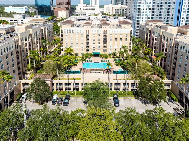 a front view of a residential apartment building with a yard in front