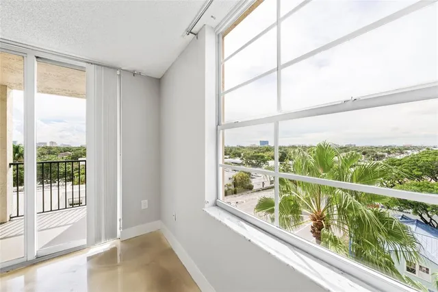 a view of a room with furniture and wooden floor