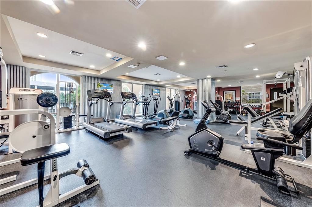 520 Southeast 5th Avenue, Unit 1504 Fort Lauderdale, FL 33301 - Photo 48 of 53 a room with gym equipment and a table