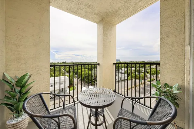 a kitchen with stainless steel appliances a stove sink microwave and window