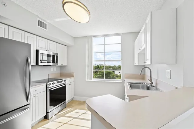 en view of an empty room with chandelier