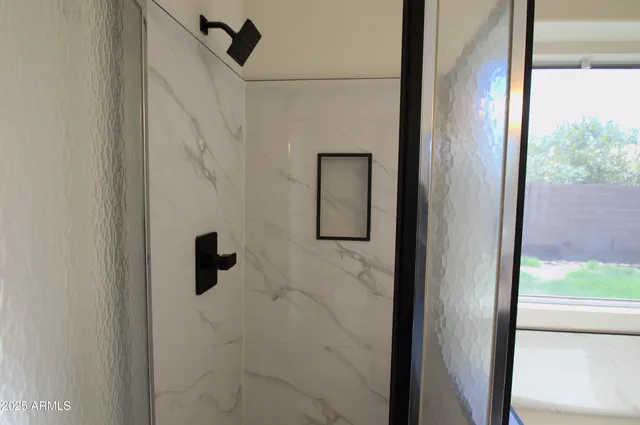 a view of a porch with a floor to ceiling window and a yard