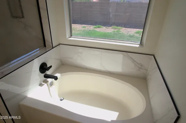a view of backyard with potted plants and wooden fence