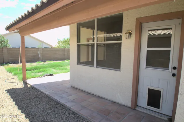 a view of backyard with wooden fence
