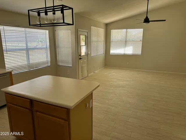 a kitchen with stainless steel appliances a refrigerator a sink and a stove