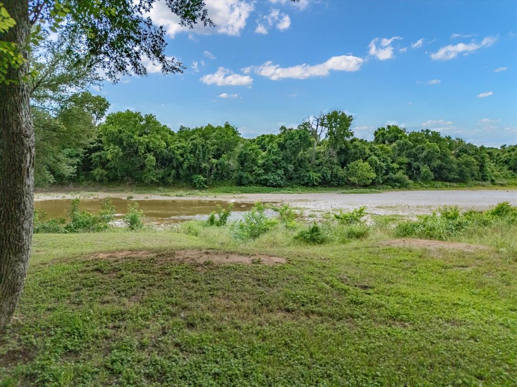 10106 Ravenswood Road Granbury, TX 76049 - Photo 31 of 39 a view of a field with an trees
