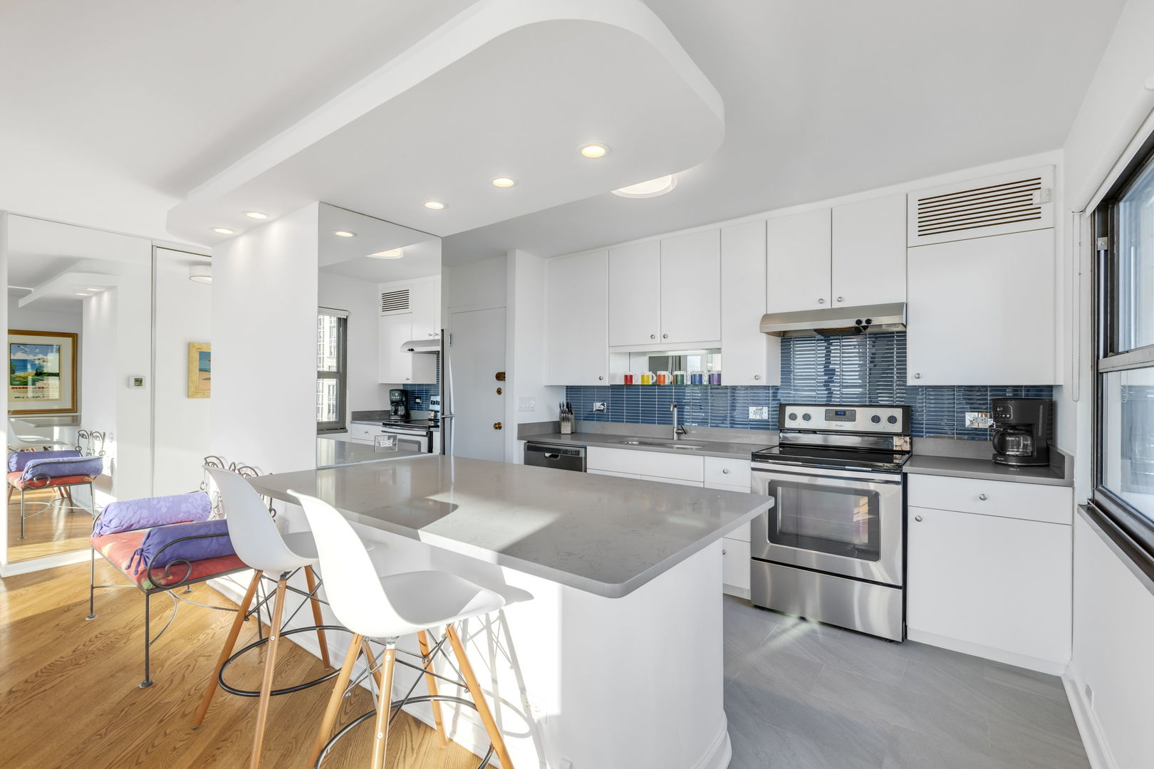 1313 North Ritchie Court, Unit 2401 Chicago, IL 60610 - Photo 14 of 29 a kitchen with stainless steel appliances granite countertop a stove top oven a sink dishwasher a dining table and chairs with wooden floor