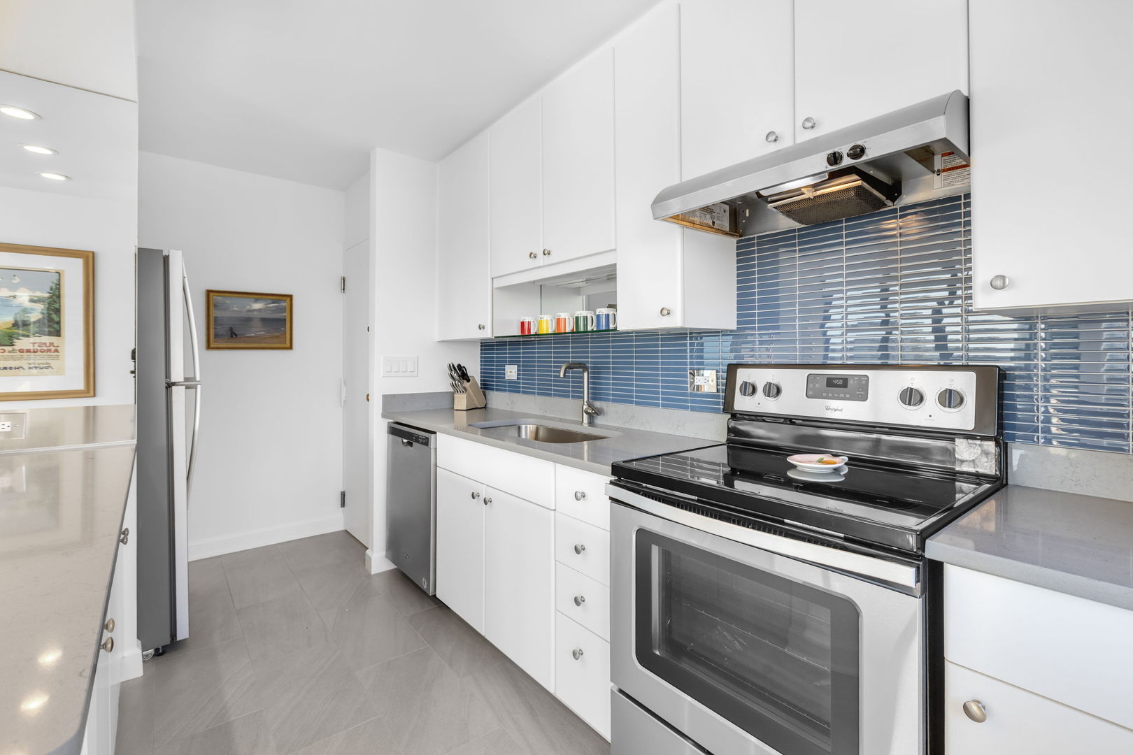 1313 North Ritchie Court, Unit 2401 Chicago, IL 60610 - Photo 16 of 29 a kitchen with a stove and white cabinets