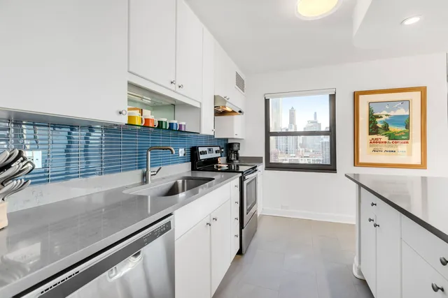 a kitchen with stainless steel appliances a sink and a stove