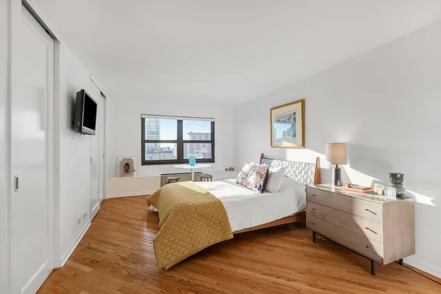 a spacious bedroom with a bed and a window