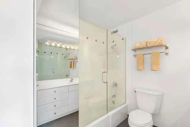 a bathroom with a toilet a sink and shower
