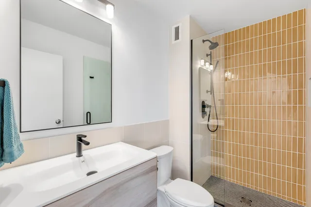 a bathroom with a sink toilet and shower