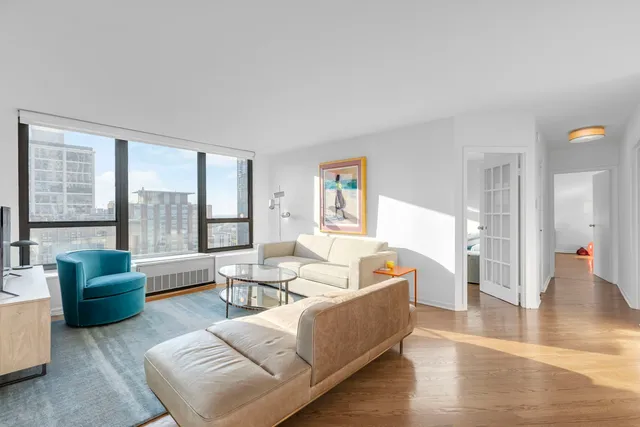 a living room with furniture and a large window