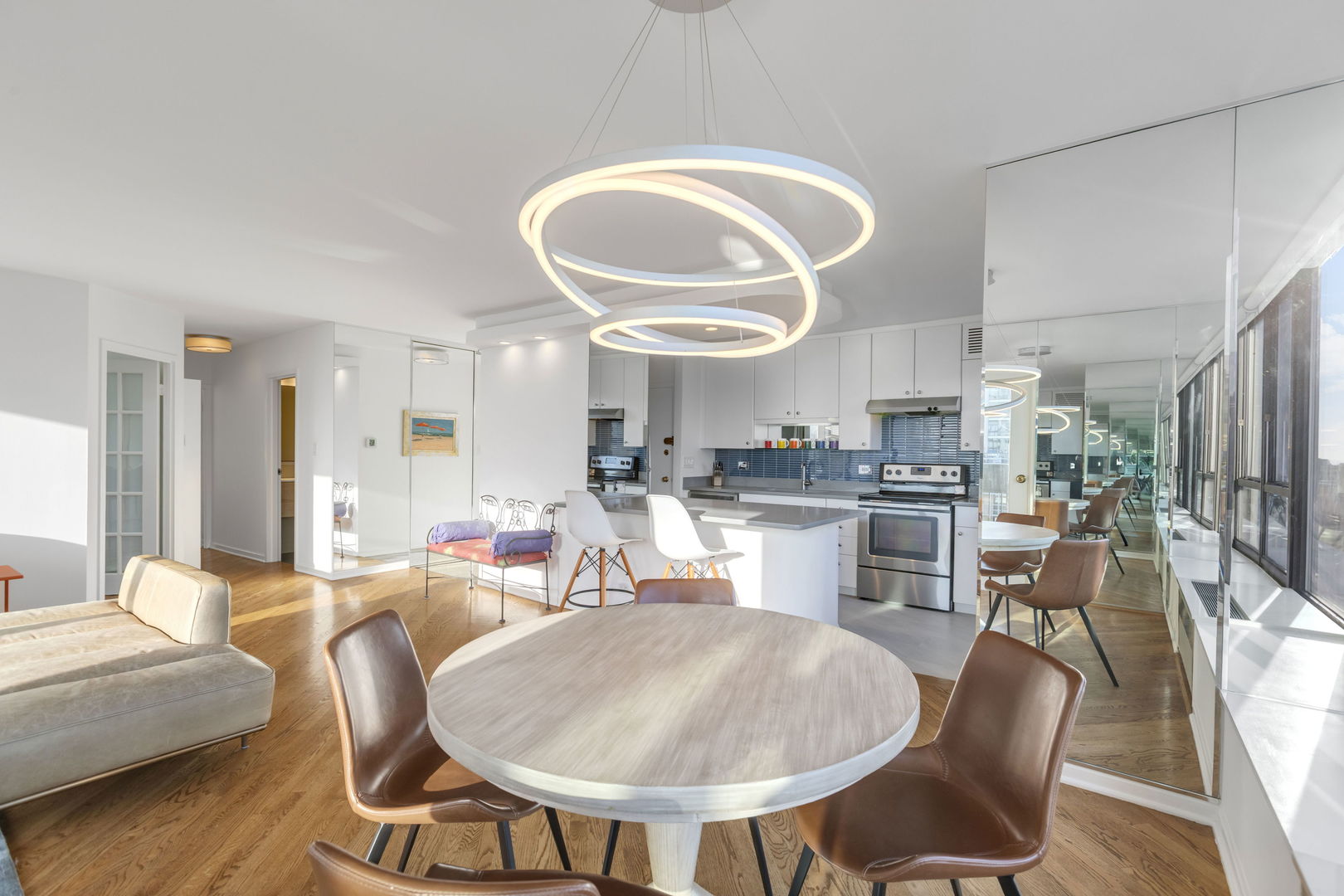 1313 North Ritchie Court, Unit 2401 Chicago, IL 60610 - Photo 10 of 29 a very nice looking dining room with kitchen island furniture a rug and a large window