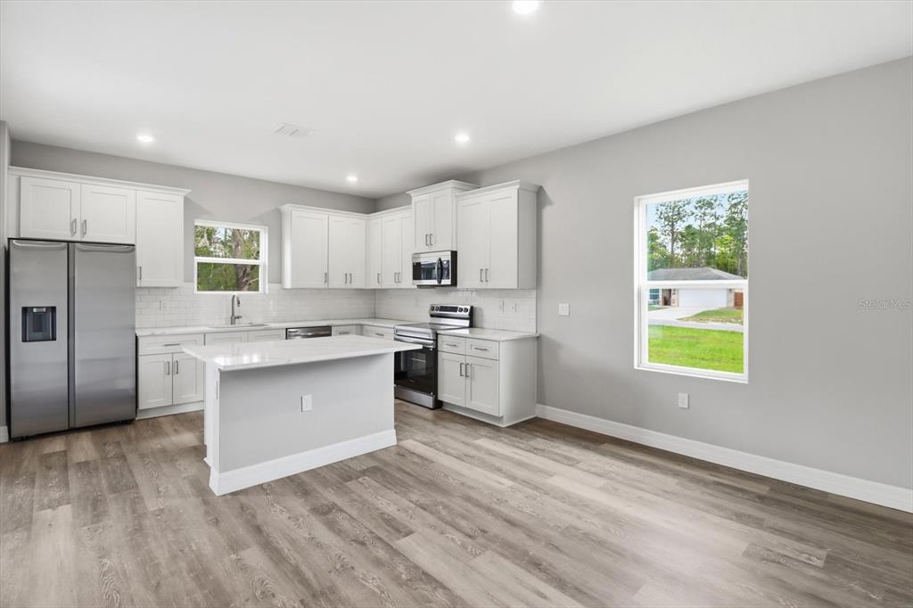 6349 Southwest 134th Loop Ocala, FL 34473 - Photo 11 of 45 a kitchen with white cabinets and window