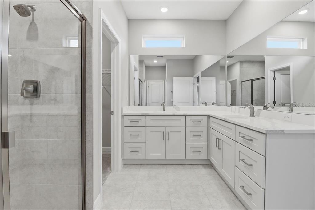 6349 Southwest 134th Loop Ocala, FL 34473 - Photo 21 of 45 a spacious bathroom with a granite countertop sink mirror and a shower