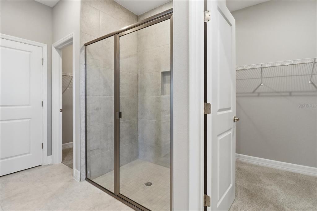 6349 Southwest 134th Loop Ocala, FL 34473 - Photo 22 of 45 a bathroom with a glass shower door