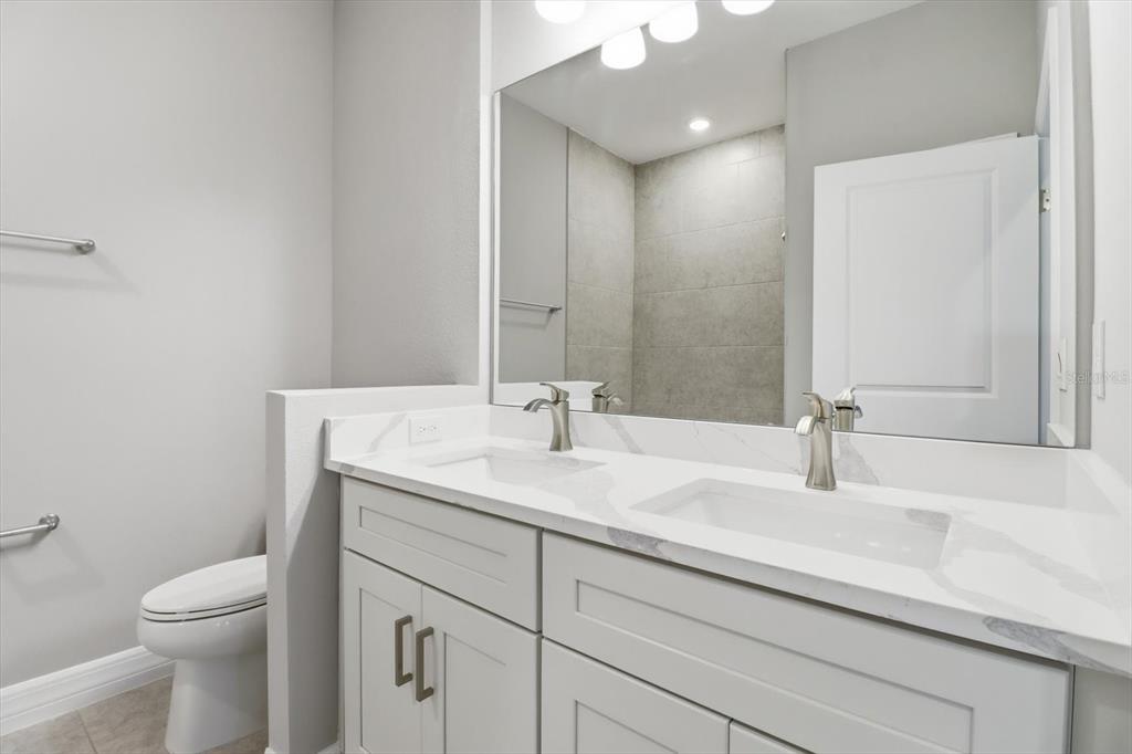 6349 Southwest 134th Loop Ocala, FL 34473 - Photo 28 of 45 a bathroom with a sink a toilet and a mirror