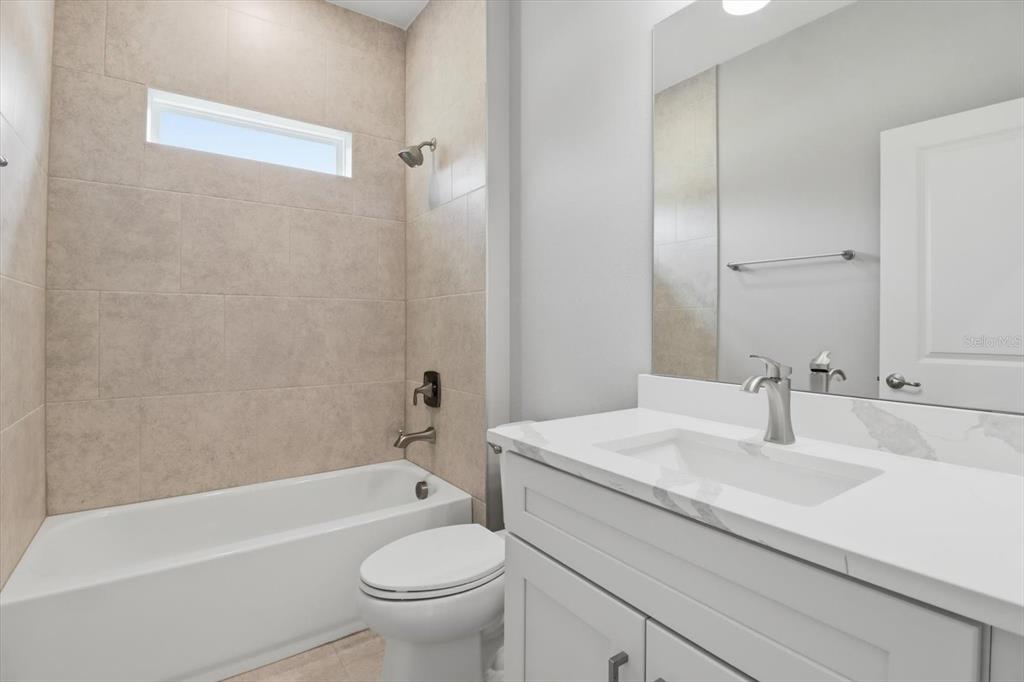 6349 Southwest 134th Loop Ocala, FL 34473 - Photo 32 of 45 a bathroom with a sink a toilet and a bathtub