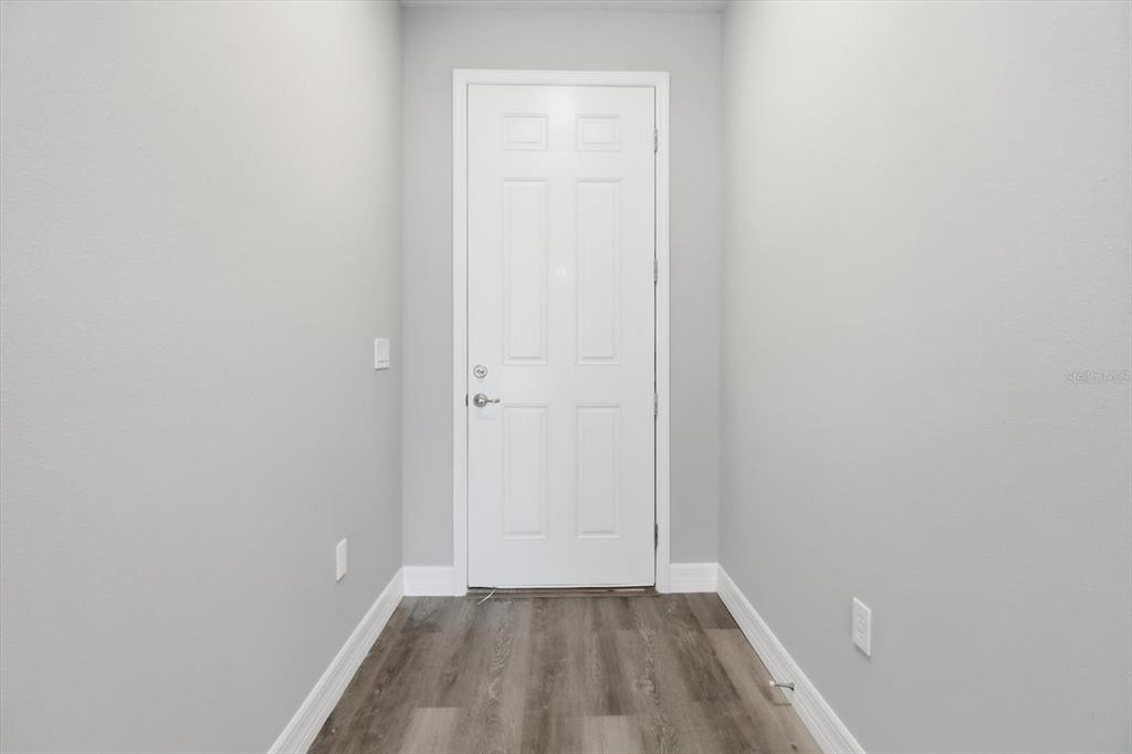 6349 Southwest 134th Loop Ocala, FL 34473 - Photo 5 of 45 a view of a small space with wooden floor and a window