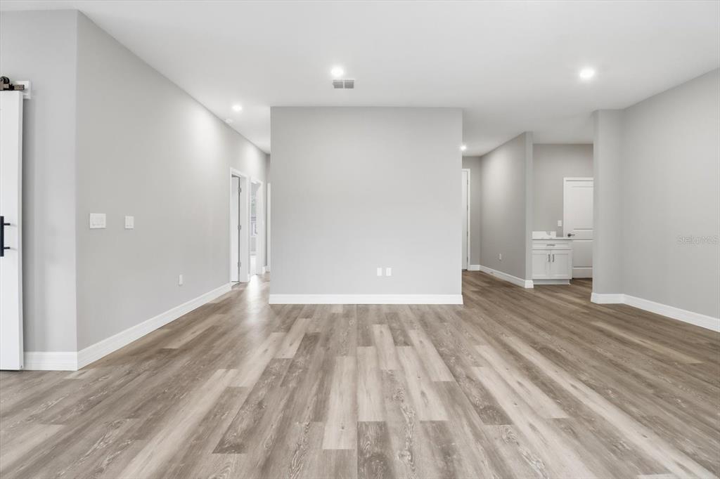 6349 Southwest 134th Loop Ocala, FL 34473 - Photo 9 of 45 a view of an empty room with wooden floor and a window