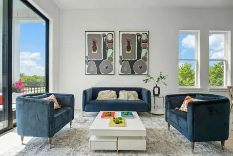 a living room with furniture and painting on the wall