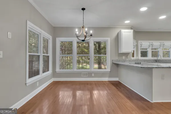 a spacious bathroom with a double vanity sink a large mirror and a bathtub