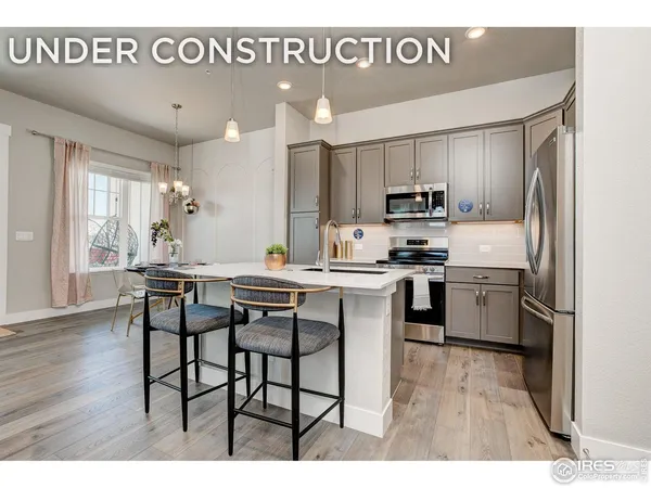 a kitchen with a sink cabinets and wooden floor