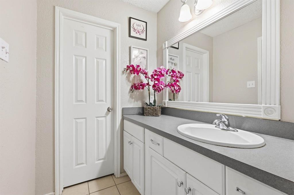 1312 Hackamore Street Mesquite, TX 75149 - Photo 14 of 23 Bathroom featuring vanity, a textured wall, and light tile patterned flooring