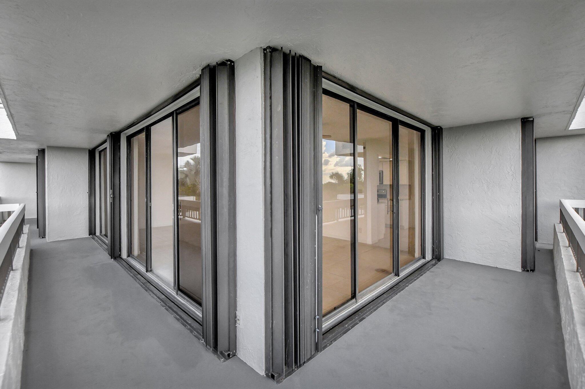 23200 Camino Del Mar, Unit 508 Boca Raton, FL 33433 - Photo 22 of 51 a view of a big room with windows and stairs