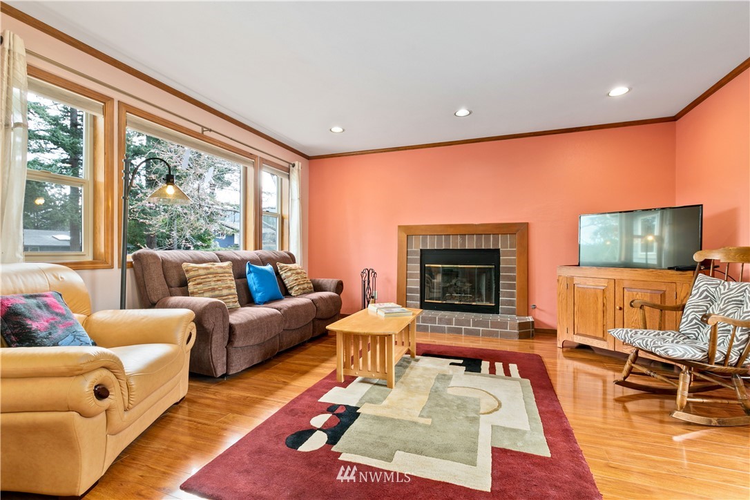 508 Cypress Road Bellingham, WA 98225 - Photo 8 of 40 a living room with furniture a large window and a fireplace