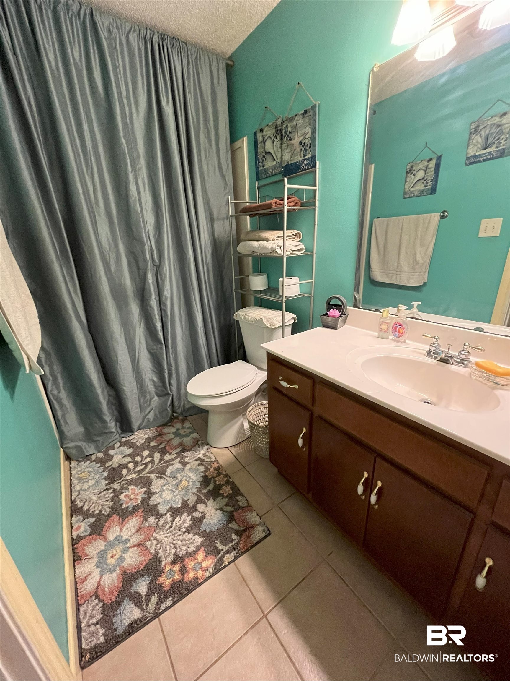 7851 Highway 98 Fairhope, AL 36532 - Photo 14 of 40 Full bathroom with a textured ceiling, light tile patterned floors, vanity, and a shower with shower curtain