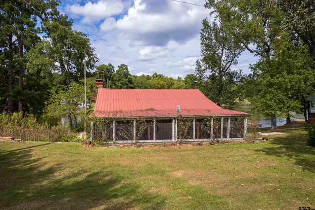 a house with swimming pool in front of it
