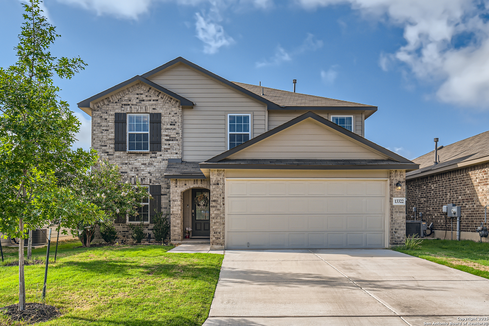 a front view of a house with a yard and garage