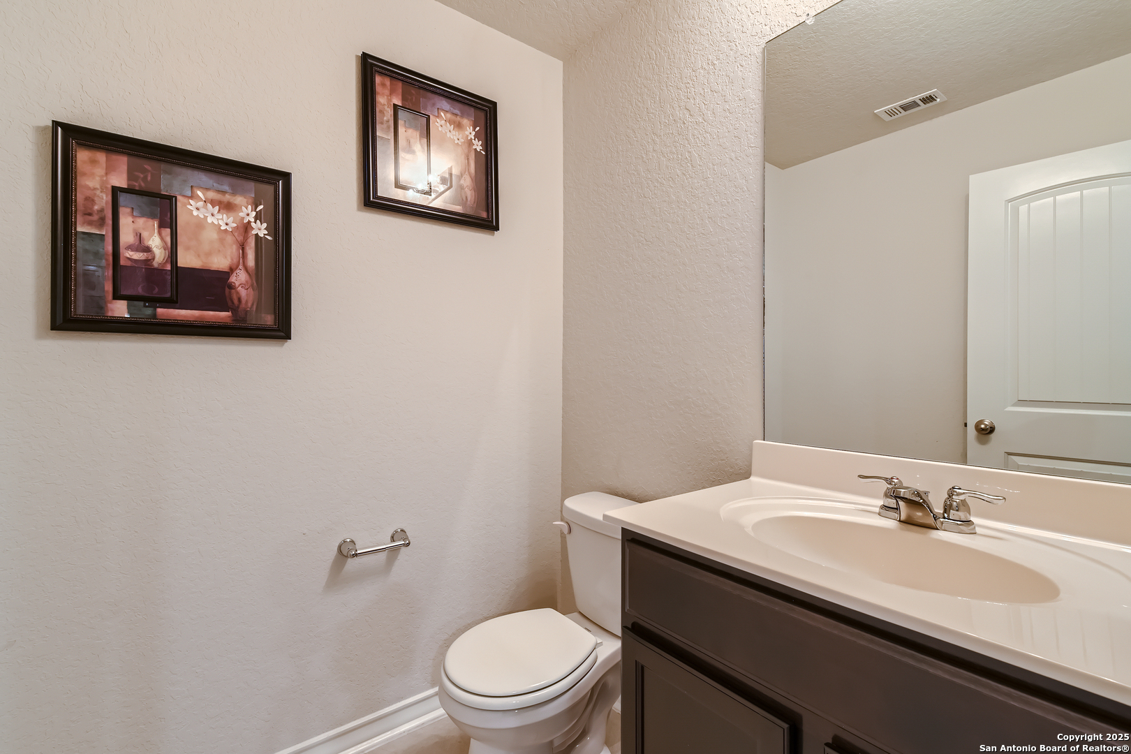 13322 Silky Rye San Antonio, TX 78254 - Photo 13 of 44 a bathroom with a toilet a sink and mirror