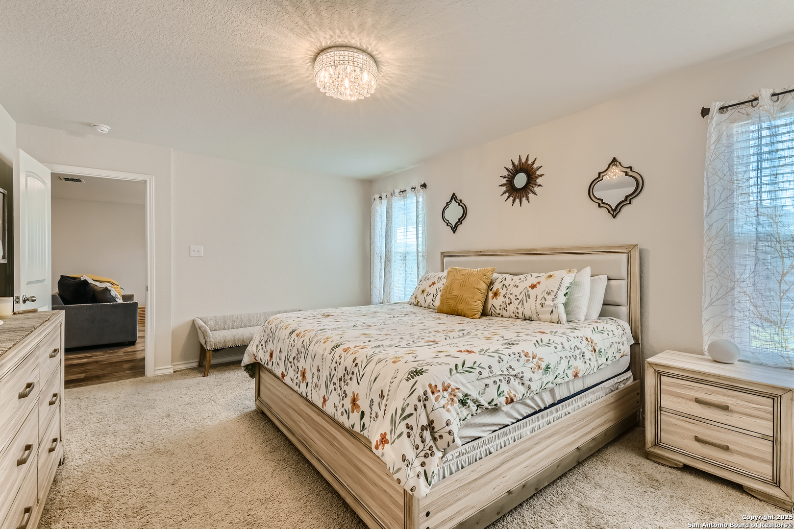 13322 Silky Rye San Antonio, TX 78254 - Photo 15 of 44 a bedroom with a bed and a chandelier