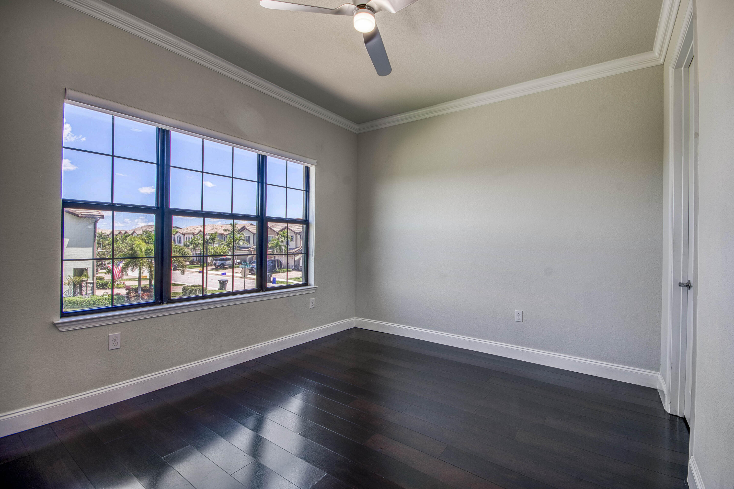 8301 Rearing Lane Lake Worth, FL 33467 - Photo 27 of 33 a view of an empty room with wooden floor and a window