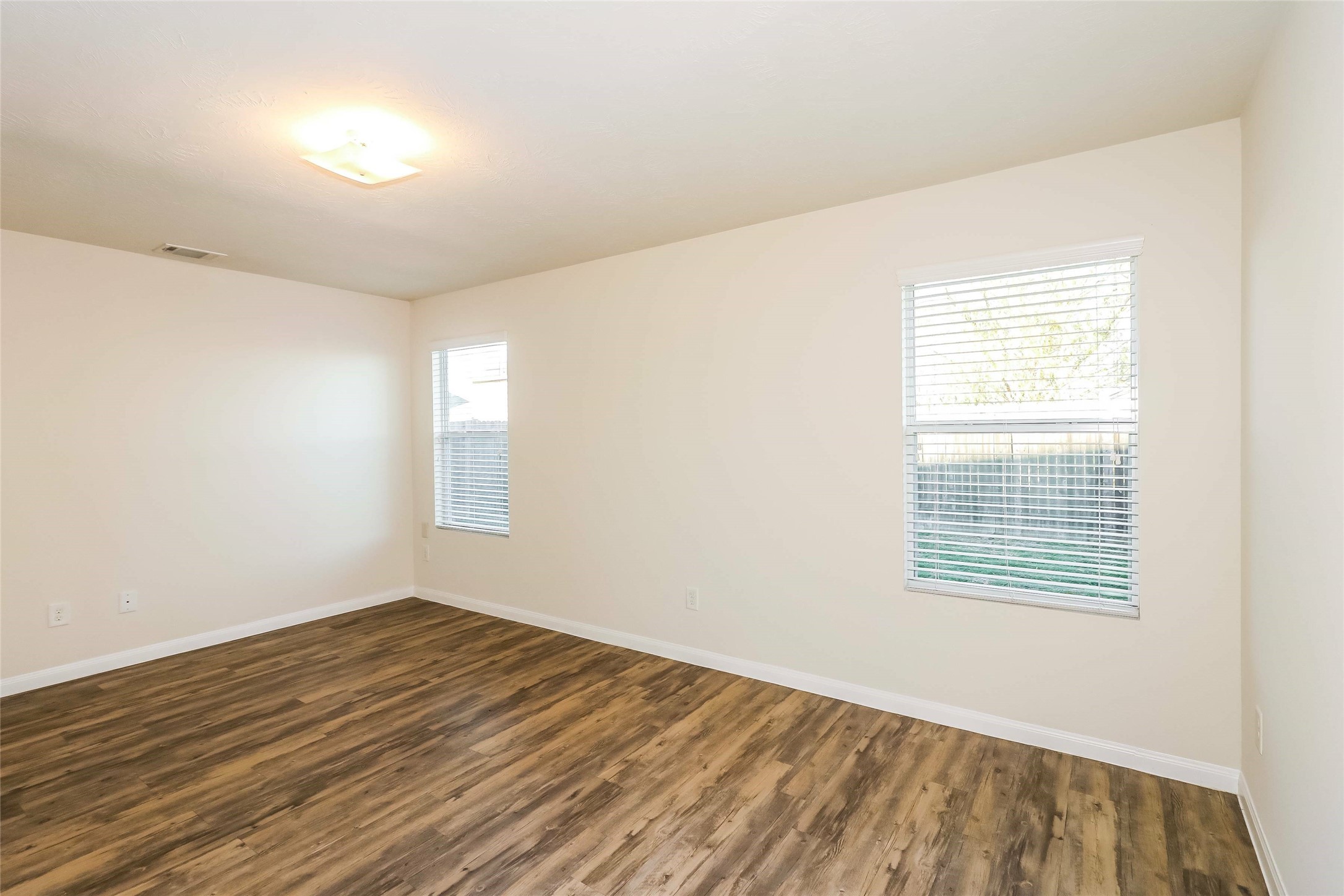 19030 Treviso Terrace Lane Katy, TX 77449 - Photo 6 of 14 a view of an empty room with wooden floor and a window