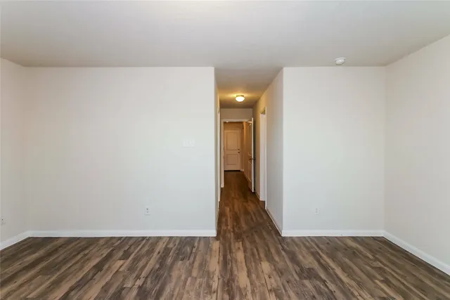 a view of hallway with wooden floor