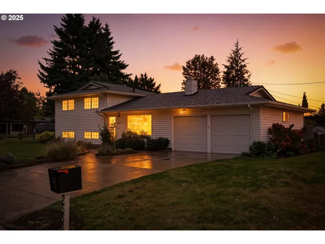 a backyard of a house with table and chairs