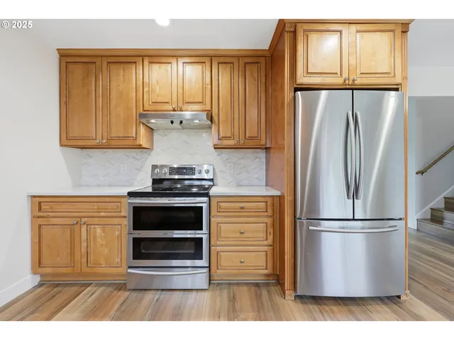 a kitchen with appliances cabinets and a window