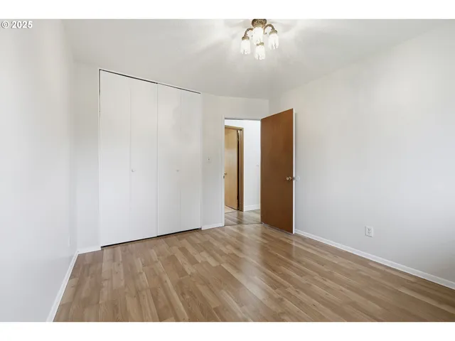 a view of an empty room with a fan