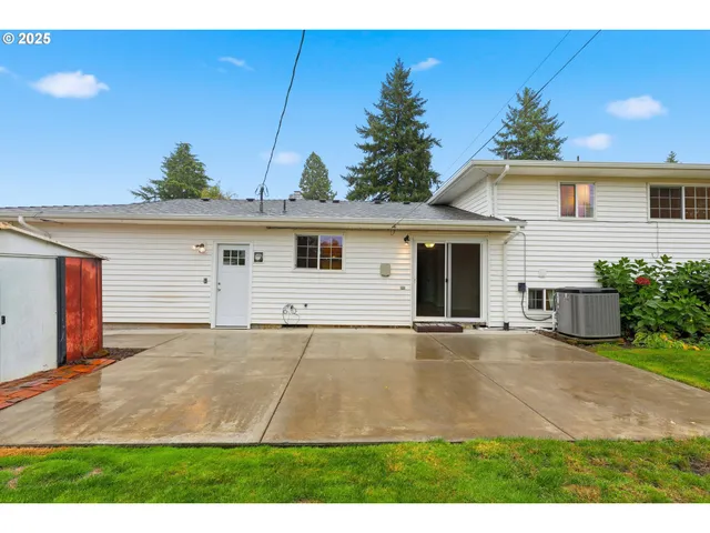 a view of the house with garage and yard