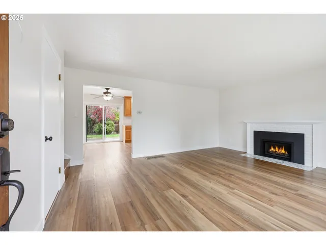 a view of an empty room and wooden floor