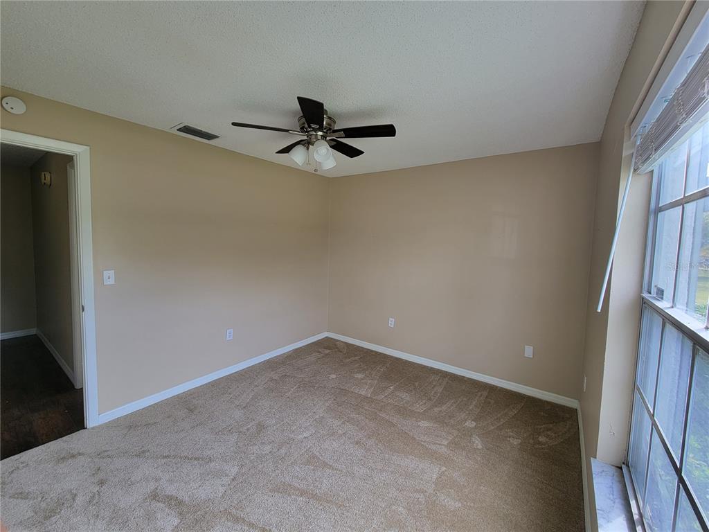 7401 Jenner Avenue New Port Richey, FL 34655 - Photo 12 of 14 wooden floor in an empty room with a window