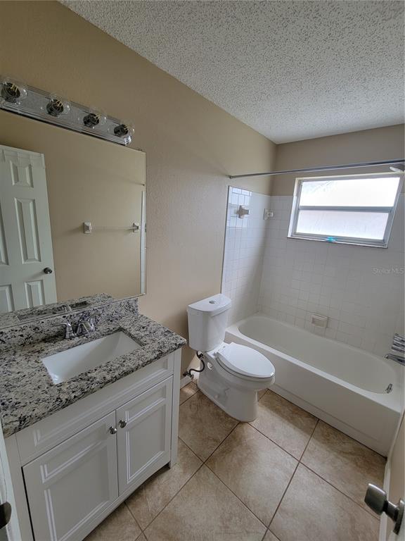 7401 Jenner Avenue New Port Richey, FL 34655 - Photo 13 of 14 a bathroom with a granite countertop sink toilet and shower
