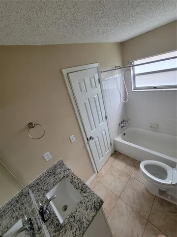 a bathroom with a sink a toilet and bathtub