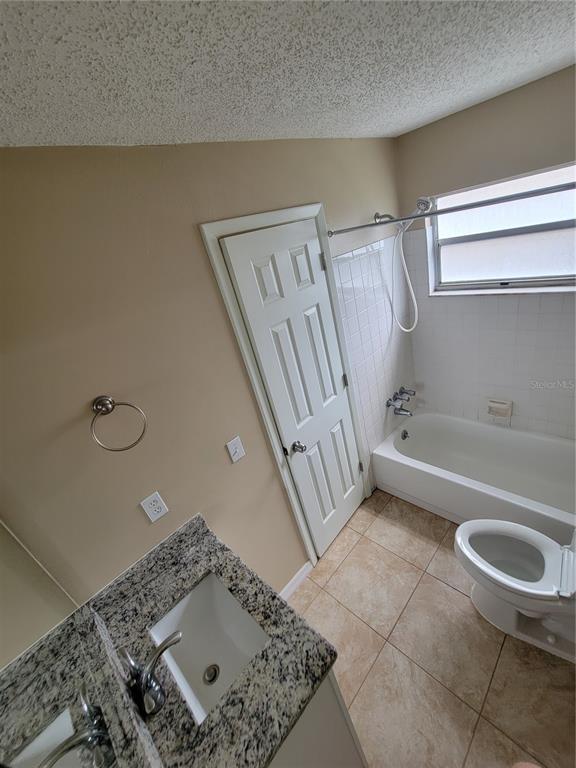 7401 Jenner Avenue New Port Richey, FL 34655 - Photo 9 of 14 a bathroom with a sink a toilet and bathtub